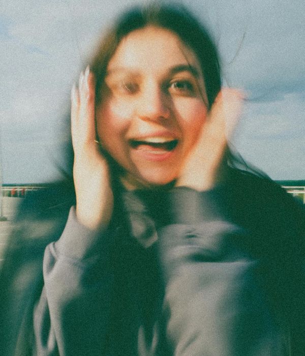 Woman feeling energetic and vibrant in a modern setting.